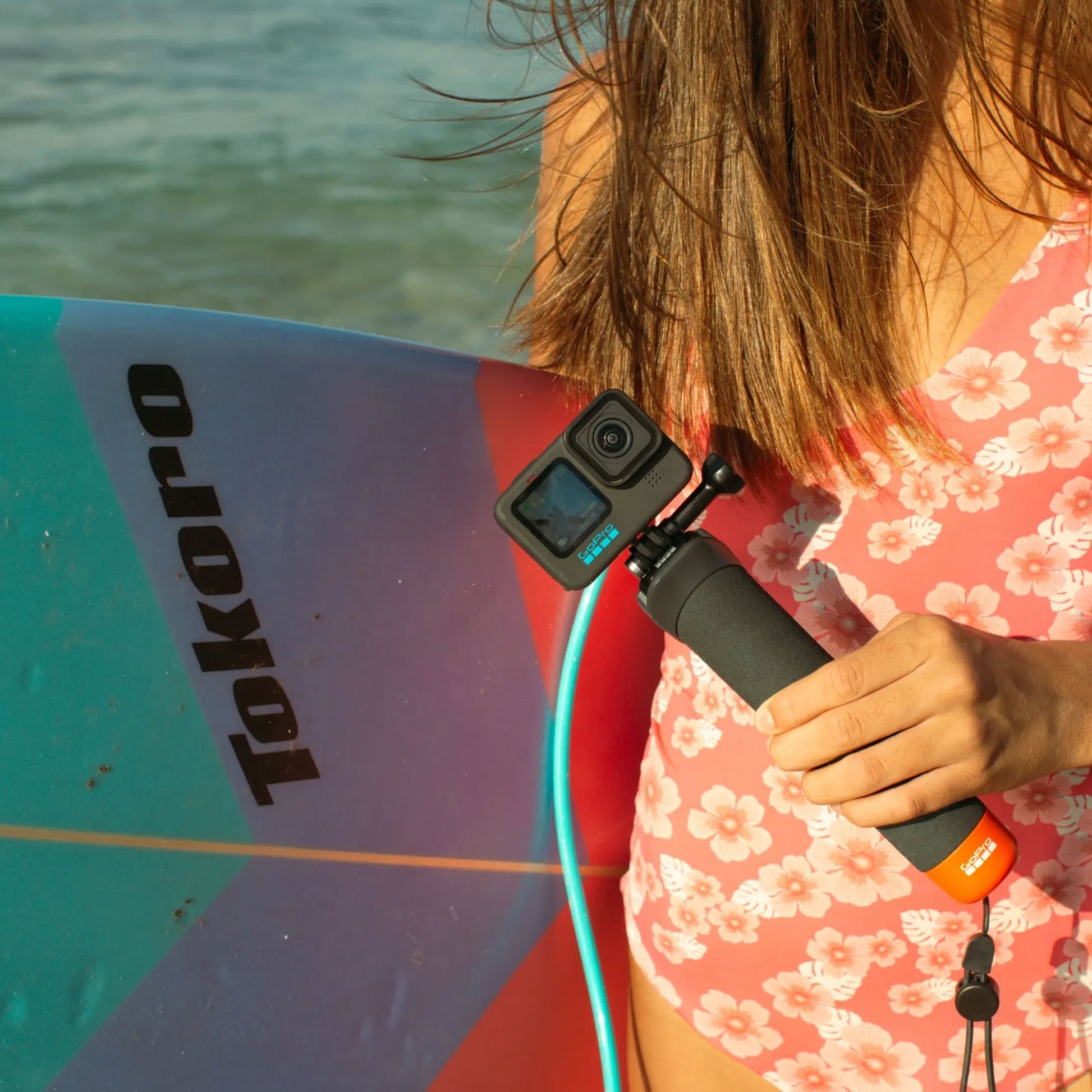 GoPro The Handler floating hand grip with orange base and quick-release camera mount
