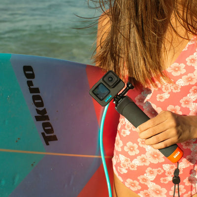GoPro The Handler floating hand grip with orange base and quick-release camera mount
