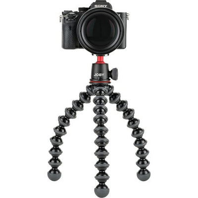 Camera on a Joby gorilla pod stand with a white background