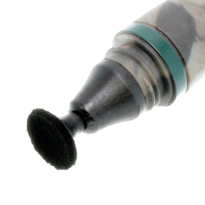 Close-up of a dental tool with a black brush head on a white background