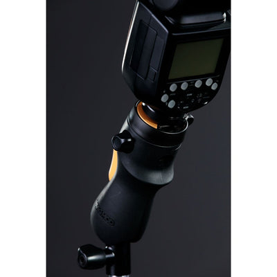 MagMod MagShoe 2 universal cold shoe bracket – ergonomic grip with orange release lever, locking mechanism for one-handed flash or modifier mounting.