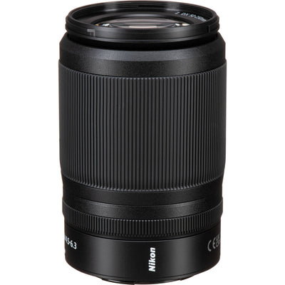 Black Nikon camera lens on a white background