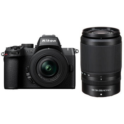 Nikon Z50 II mirrorless camera kit in black featuring two NIKKOR Z lenses (16–50 mm and 50–250 mm), with 3.2″ tilting touchscreen, built-in electronic viewfinder, and ergonomic textured grip.