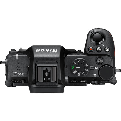 Nikon Z50 II Vlogging Kit in black featuring the Z50 II mirrorless camera body with attached NIKKOR Z 16–50 mm lens, alongside accessories including a compact vlogging LED light, shotgun microphone on cold shoe, handheld grip with wrist strap, and USB-C cable for charging.