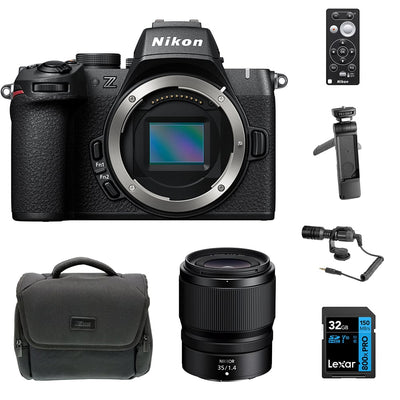 Nikon Z50 II Vlogging Kit in black featuring the Z50 II mirrorless camera body with attached NIKKOR Z 16–50 mm lens, alongside accessories including a compact vlogging LED light, shotgun microphone on cold shoe, handheld grip with wrist strap, and USB-C cable for charging.