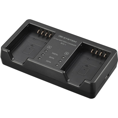 Olympus SBCX-1 kit includes one BLX-1 2280mAh lithium-ion battery and BCX-1 dual battery charger, charges two batteries simultaneously in about 150 minutes via USB-C with power delivery