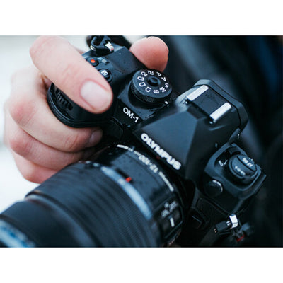 OM System OM-1 mirrorless camera with 20MP stacked BSI Live MOS sensor, TruePic X processor, paired with bright 12-40mm f/2.8 Pro II weather-sealed zoom lens, 5-axis IBIS, 4K 60p video, and fast autofocus.