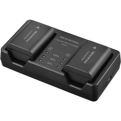 Olympus SBCX-1 kit includes one BLX-1 2280mAh lithium-ion battery and BCX-1 dual battery charger, charges two batteries simultaneously in about 150 minutes via USB-C with power delivery