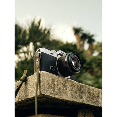 OM System OM-3 mirrorless camera with 20MP stacked BSI Live MOS sensor, TruePic X processor, 1053-point Quad Pixel AF covering 100% frame, up to 50 fps continuous AF burst, 4K 60p video, IP53 weather sealing, and 3-inch vari-angle touchscreen.