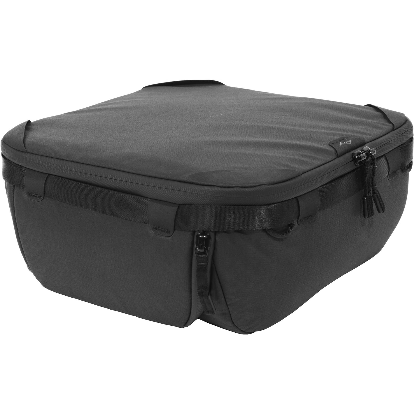Black handheld Peak Design Camera Cube V2 with adjustable dividers, zipper closure, and durable nylon exterior, perfect for carrying camera gear safely.
