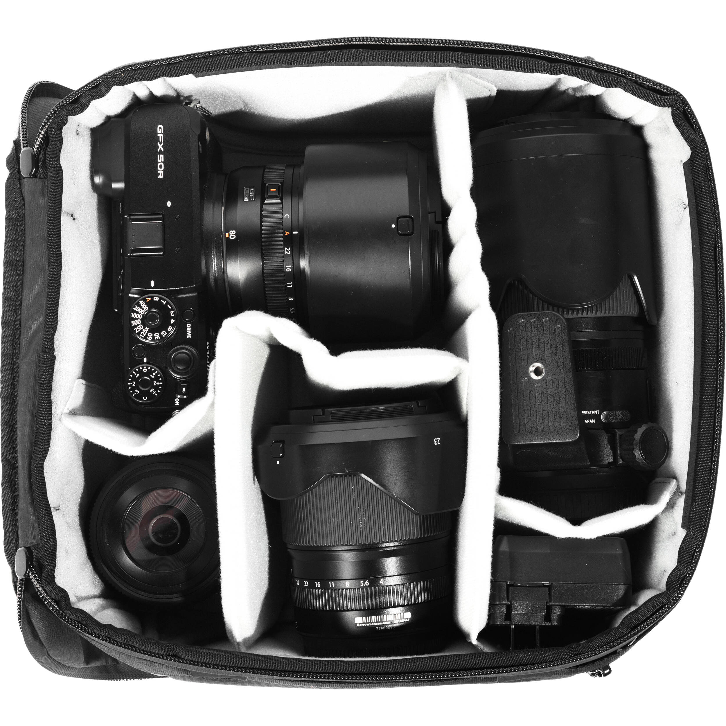 Black handheld Peak Design Camera Cube V2 with adjustable dividers, zipper closure, and durable nylon exterior, perfect for carrying camera gear safely.
