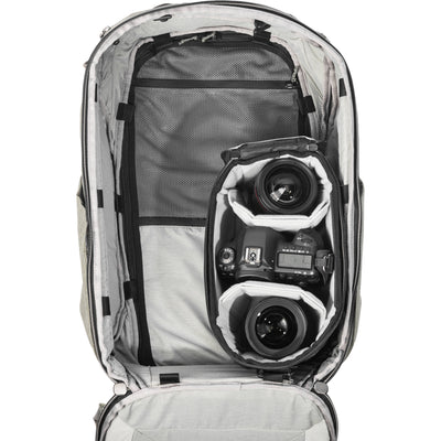 Black handheld Peak Design Camera Cube V2 with adjustable dividers, zipper closure, and durable nylon exterior, perfect for carrying camera gear safely.
