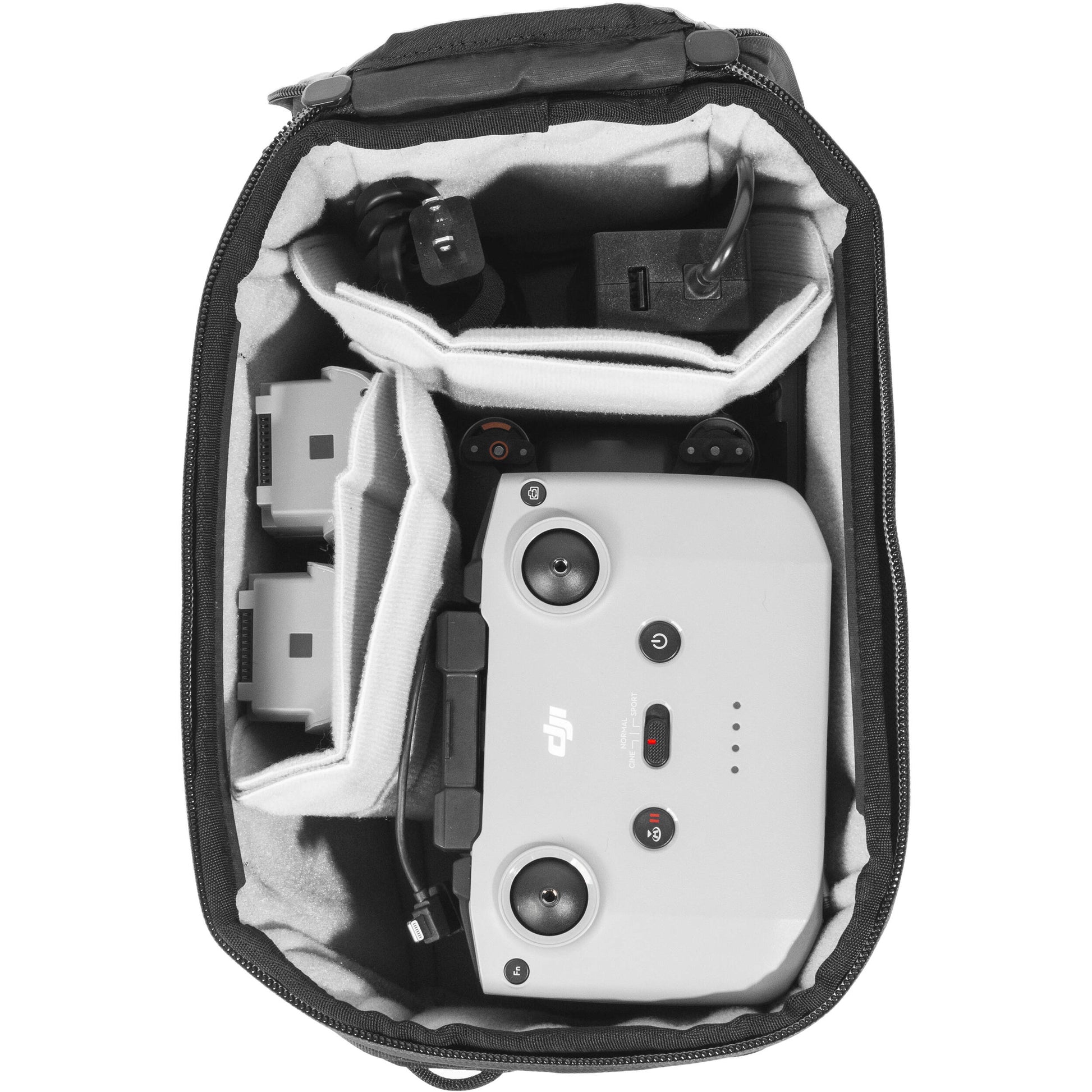 Black handheld Peak Design Camera Cube V2 with adjustable dividers, zipper closure, and durable nylon exterior, perfect for carrying camera gear safely.
