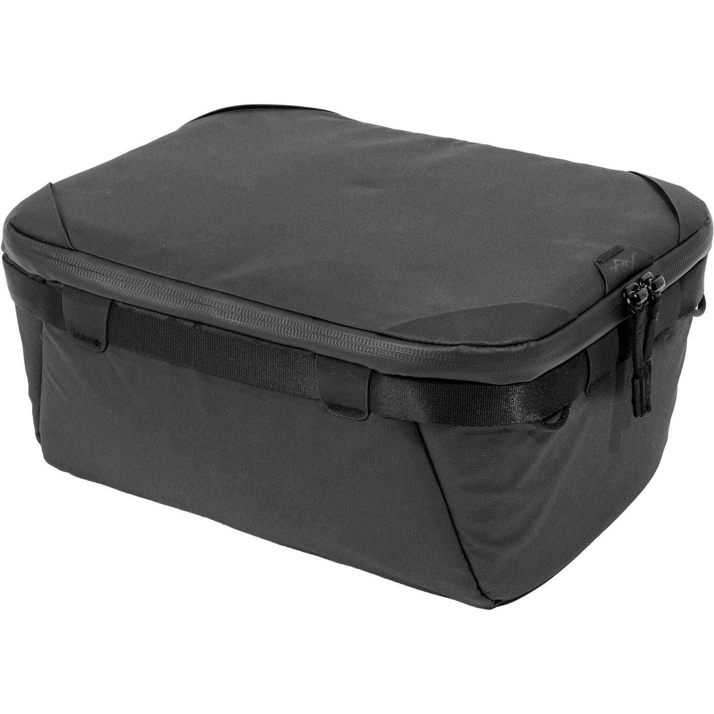 Black handheld Peak Design Camera Cube V2 with adjustable dividers, zipper closure, and durable nylon exterior, perfect for carrying camera gear safely.
