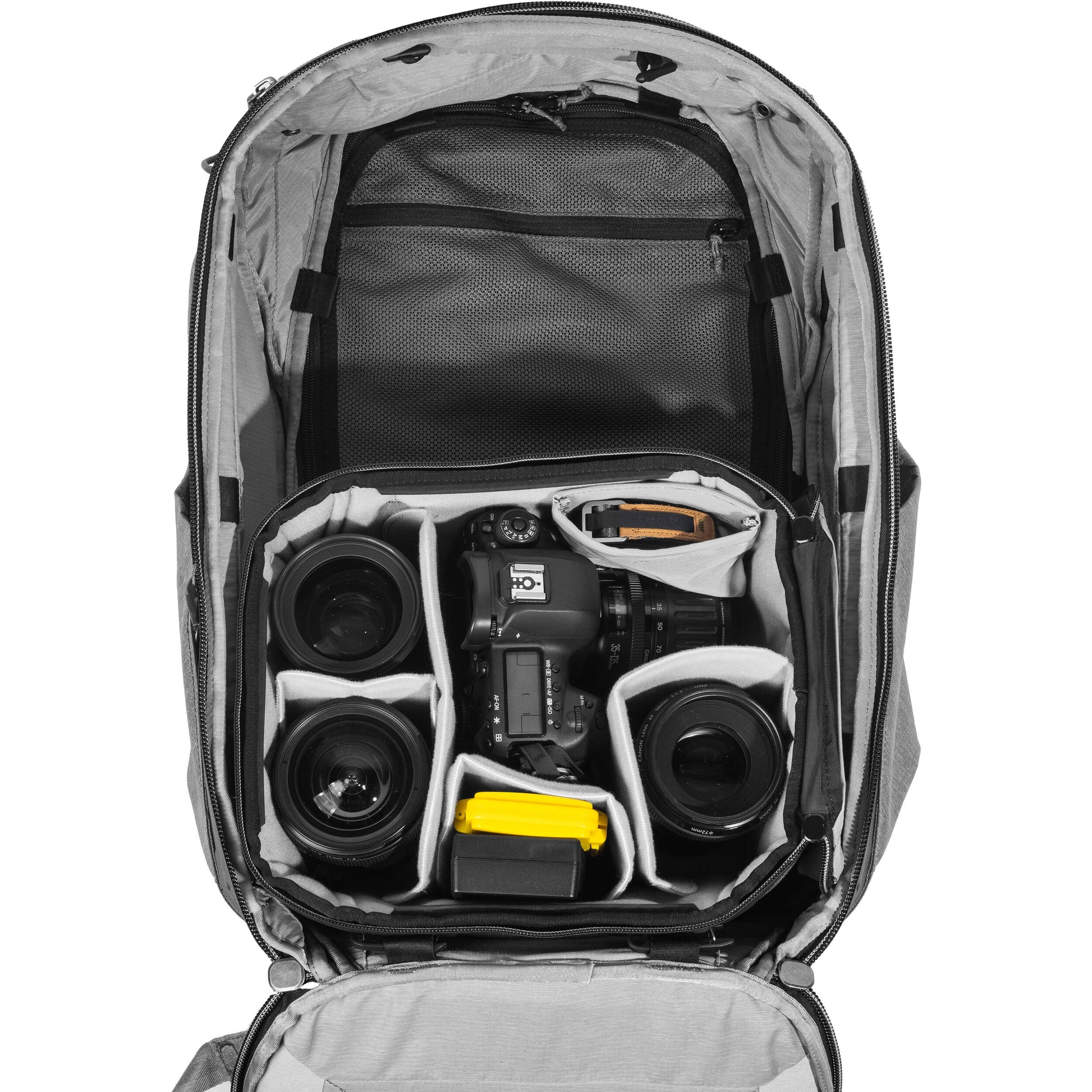 Black handheld Peak Design Camera Cube V2 with adjustable dividers, zipper closure, and durable nylon exterior, perfect for carrying camera gear safely.
