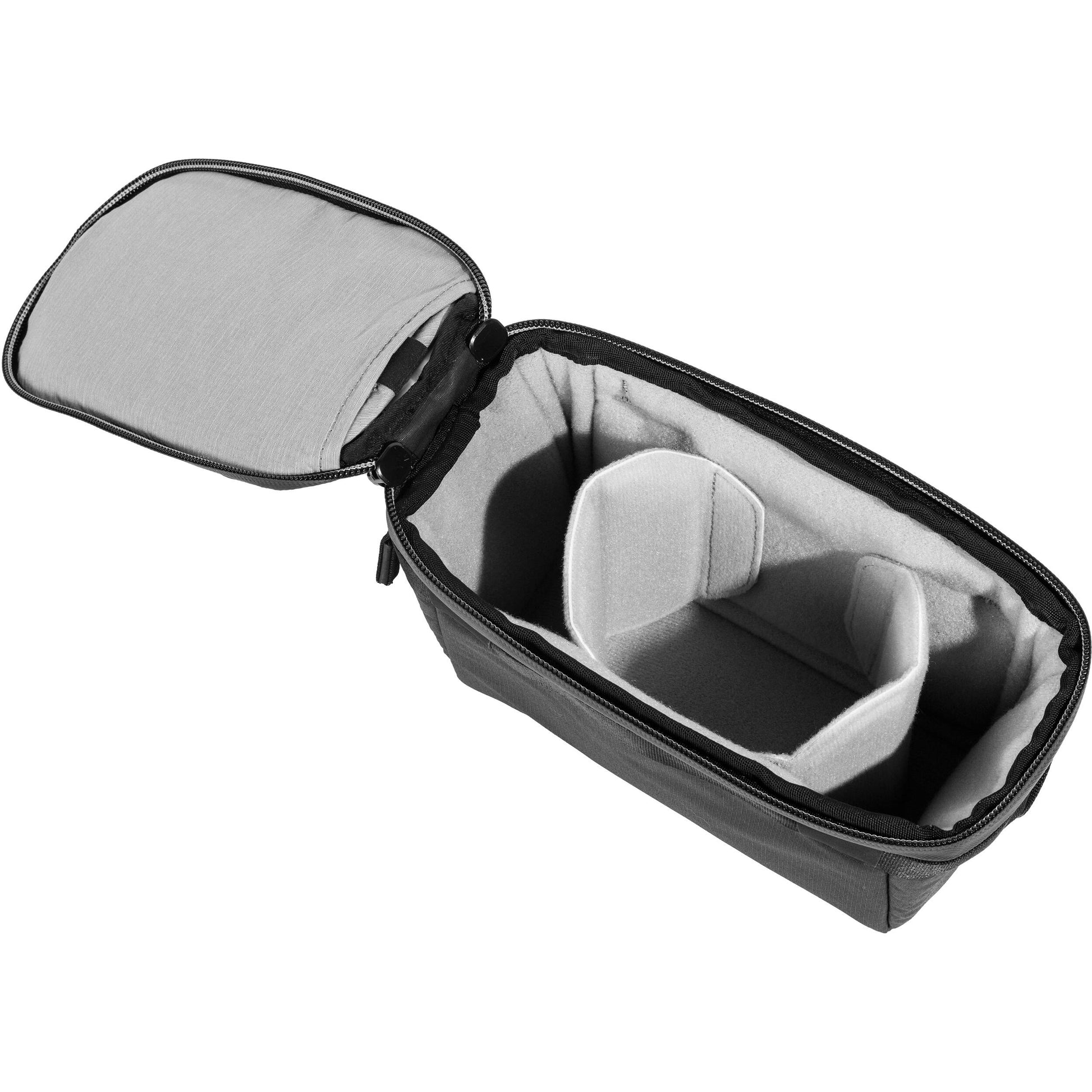 Black handheld Peak Design Camera Cube V2 with adjustable dividers, zipper closure, and durable nylon exterior, perfect for carrying camera gear safely.
