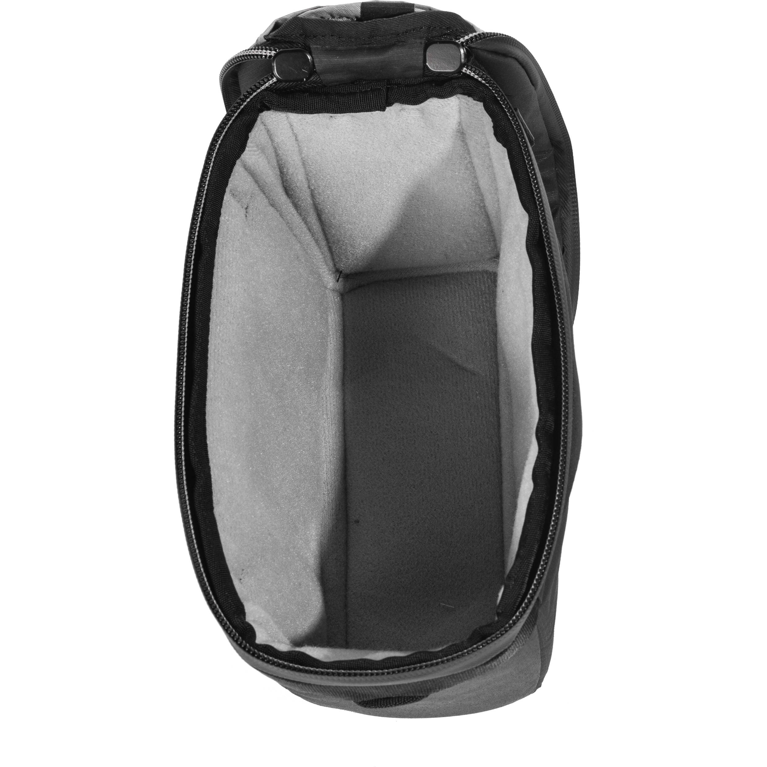 Black handheld Peak Design Camera Cube V2 with adjustable dividers, zipper closure, and durable nylon exterior, perfect for carrying camera gear safely.

