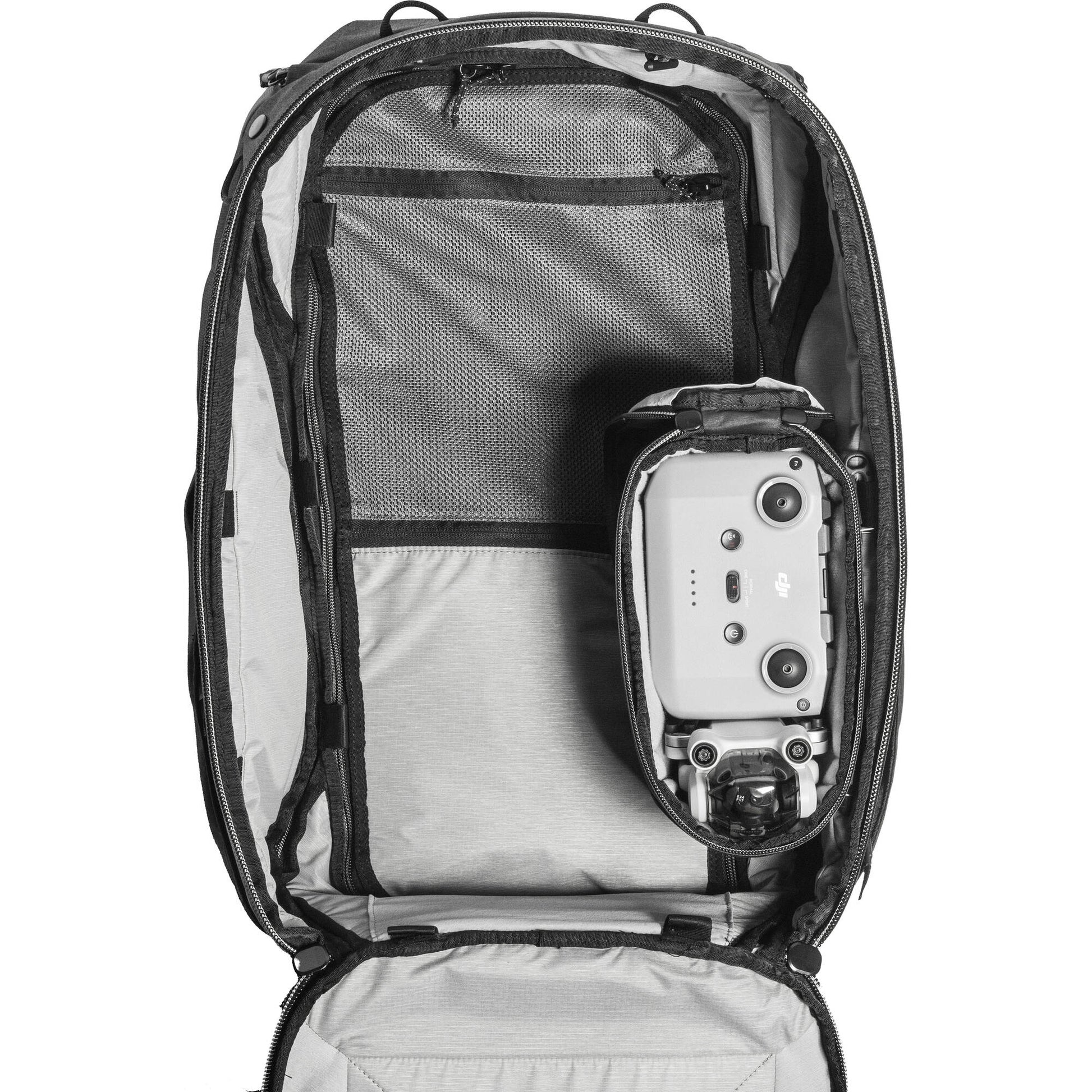 Black handheld Peak Design Camera Cube V2 with adjustable dividers, zipper closure, and durable nylon exterior, perfect for carrying camera gear safely.
