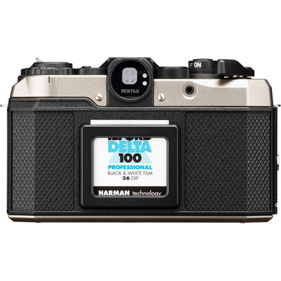 Vintage Pentax camera with a roll of Ilford Delta 100 film displayed on the back. Film not included with the camera.