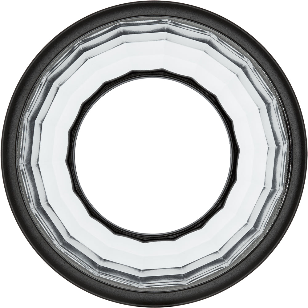Close-up of a clear glass with black rim on a white background