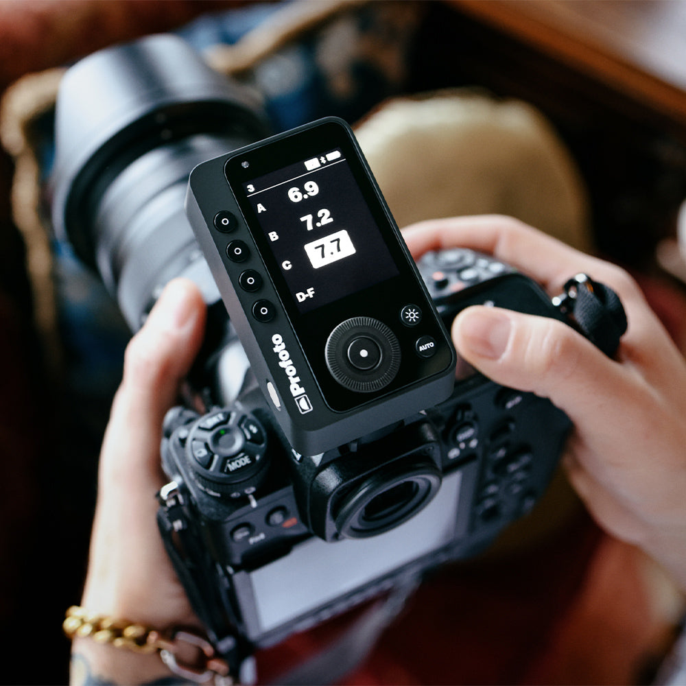 Person adjusting camera settings on a camera with a digital display