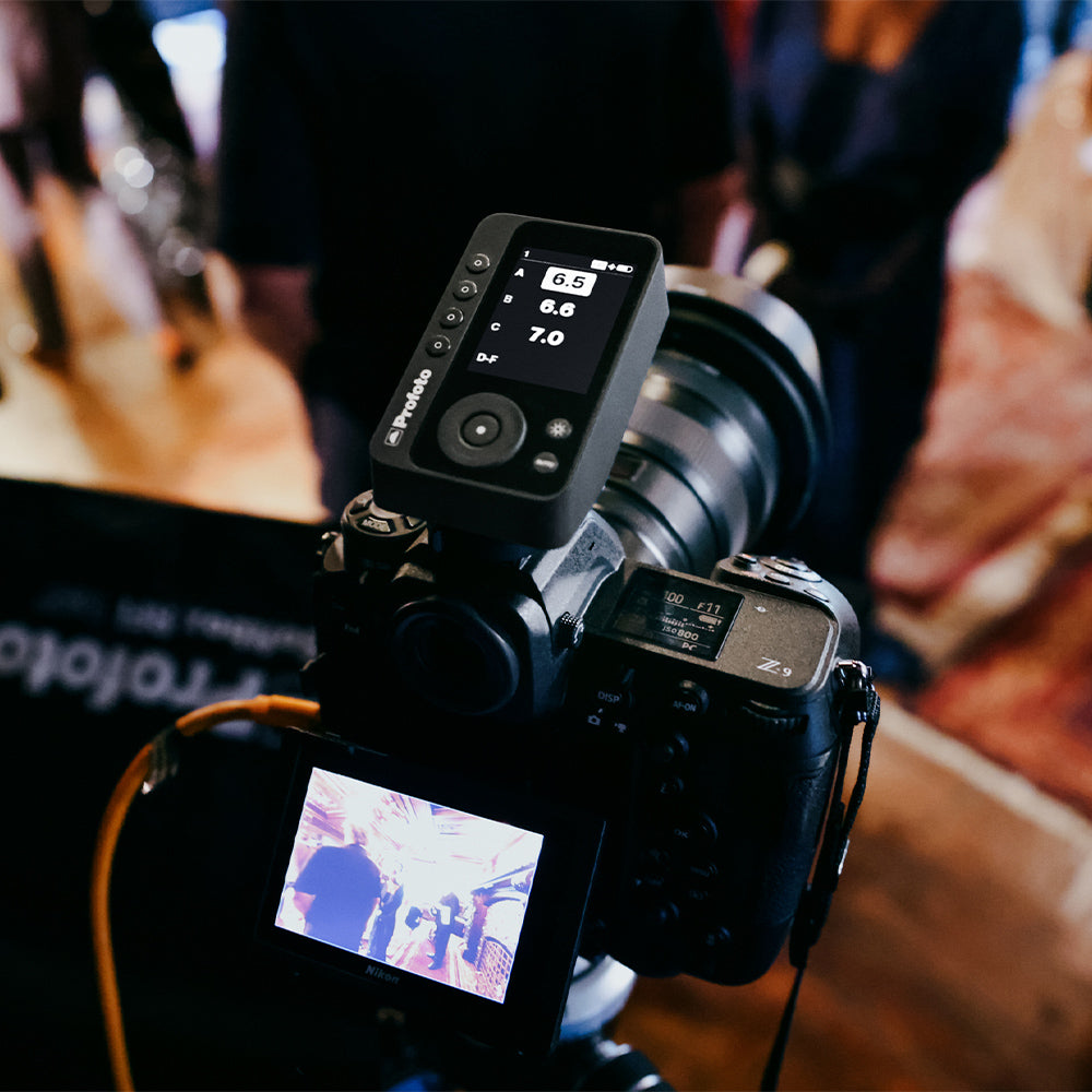 Camera with lens and attached device on a blurred background