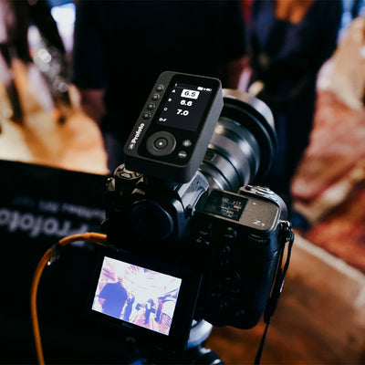 Camera with lens and attached device on a blurred background