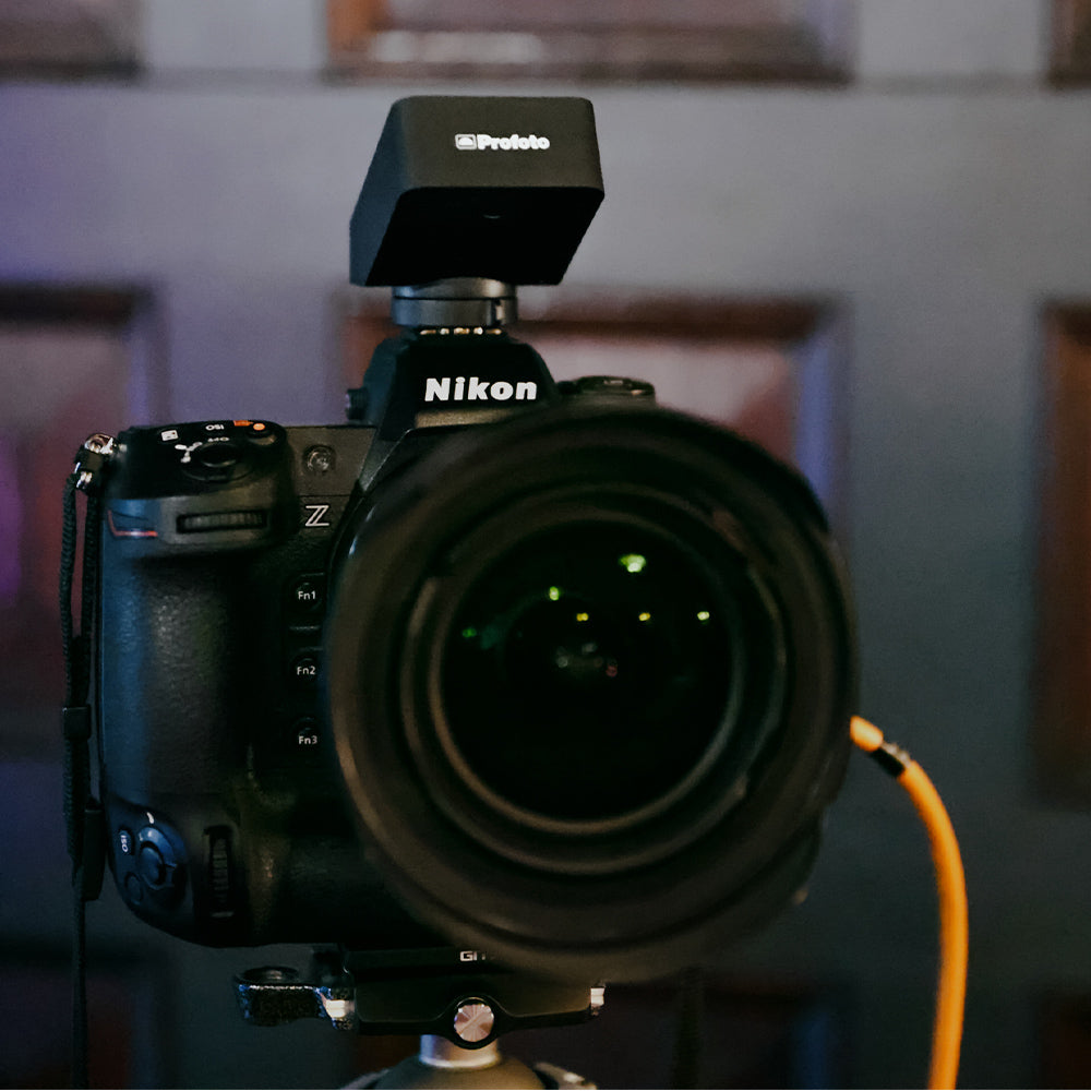 Nikon camera with a lens cap on a blurred background