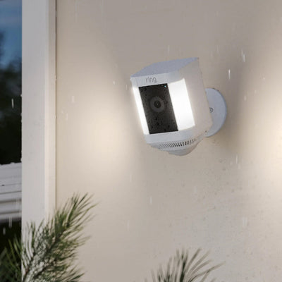Ring Spotlight Cam Plus Battery Outdoor Security Camera with Spotlights in White lifestyle image