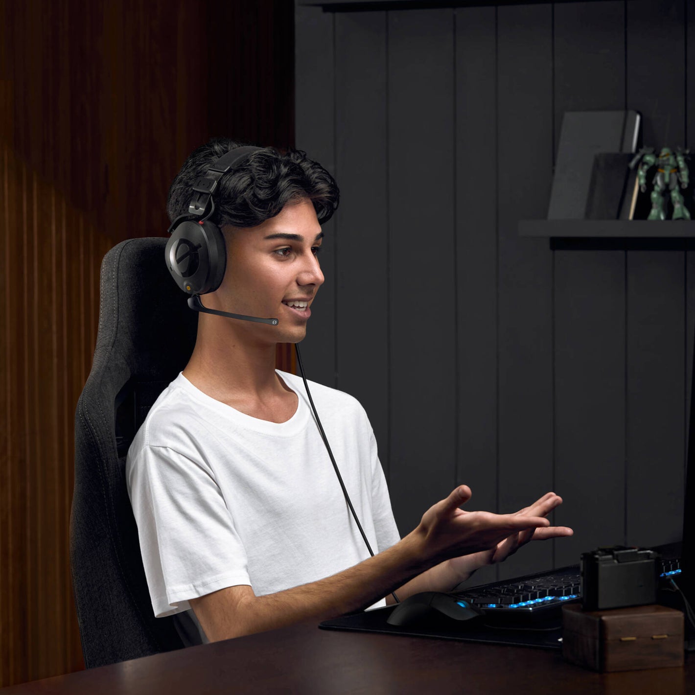Black over-ear professional headset with adjustable boom microphone, detachable straight cable, and closed-back design.