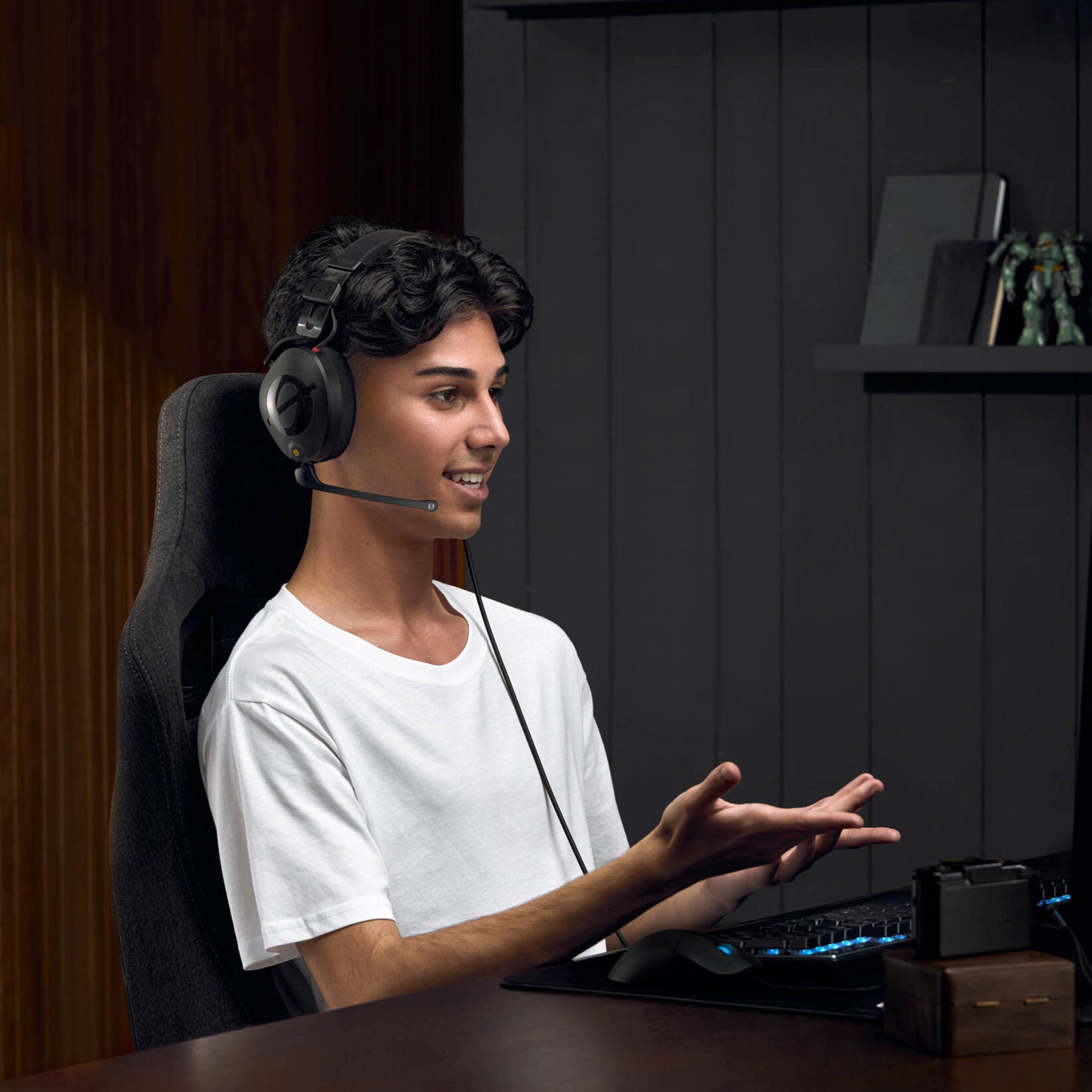 Black over-ear professional headset with adjustable boom microphone, detachable straight cable, and closed-back design.