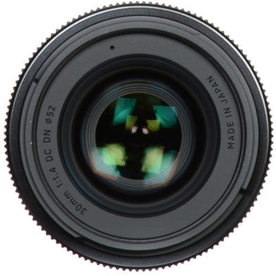 Close-up of a camera lens with 'Made in Japan' text on a white background