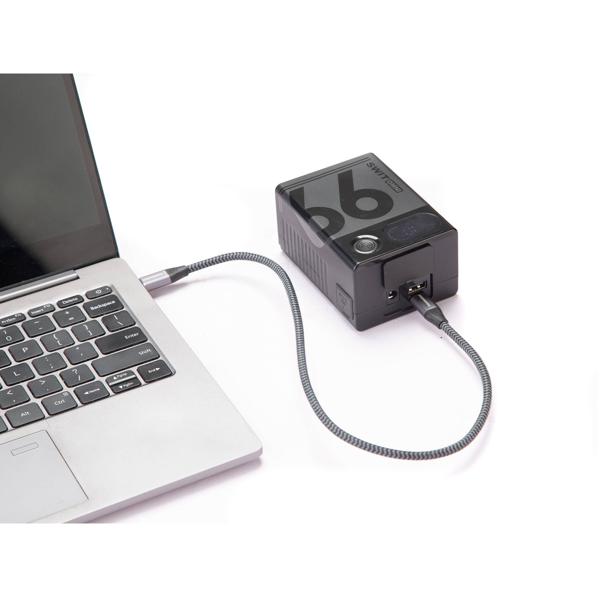 Portable SWIT OMNI-99S 99Wh V-Mount battery for cameras and accessories with USB-C charging.
