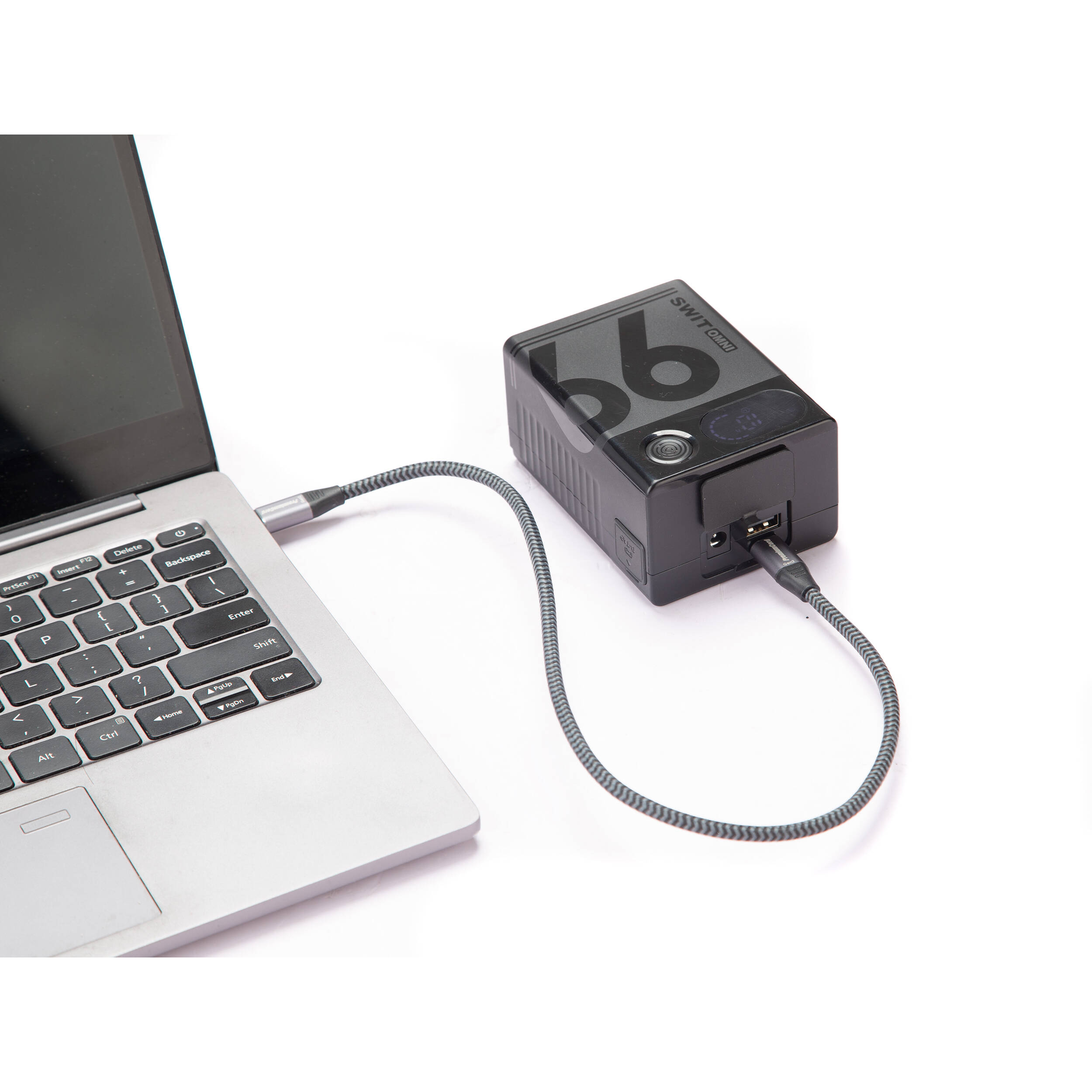 Portable SWIT OMNI-99S 99Wh V-Mount battery for cameras and accessories with USB-C charging.
