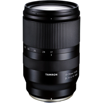 Black camera lens with 'Tamron' branding on a white background