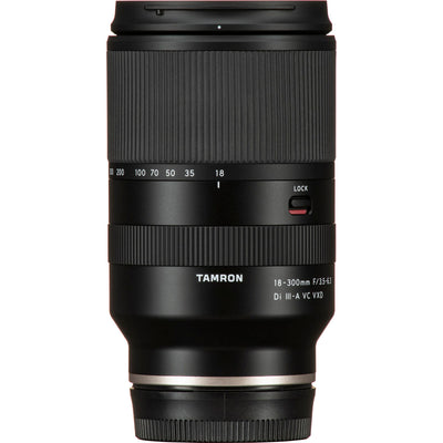 Black camera lens with Tamron branding on a white background