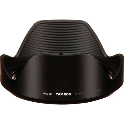 Black camera lens hood with Tamron branding on a white background