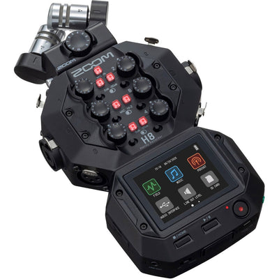 Zoom H8 portable handy recorder showing its color touchscreen, X/Y mic capsule, multiple input gain knobs, outputs and buttons, viewed at slight angle against a neutral background.