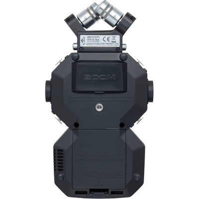 Zoom H8 portable handy recorder showing its color touchscreen, X/Y mic capsule, multiple input gain knobs, outputs and buttons, viewed at slight angle against a neutral background.